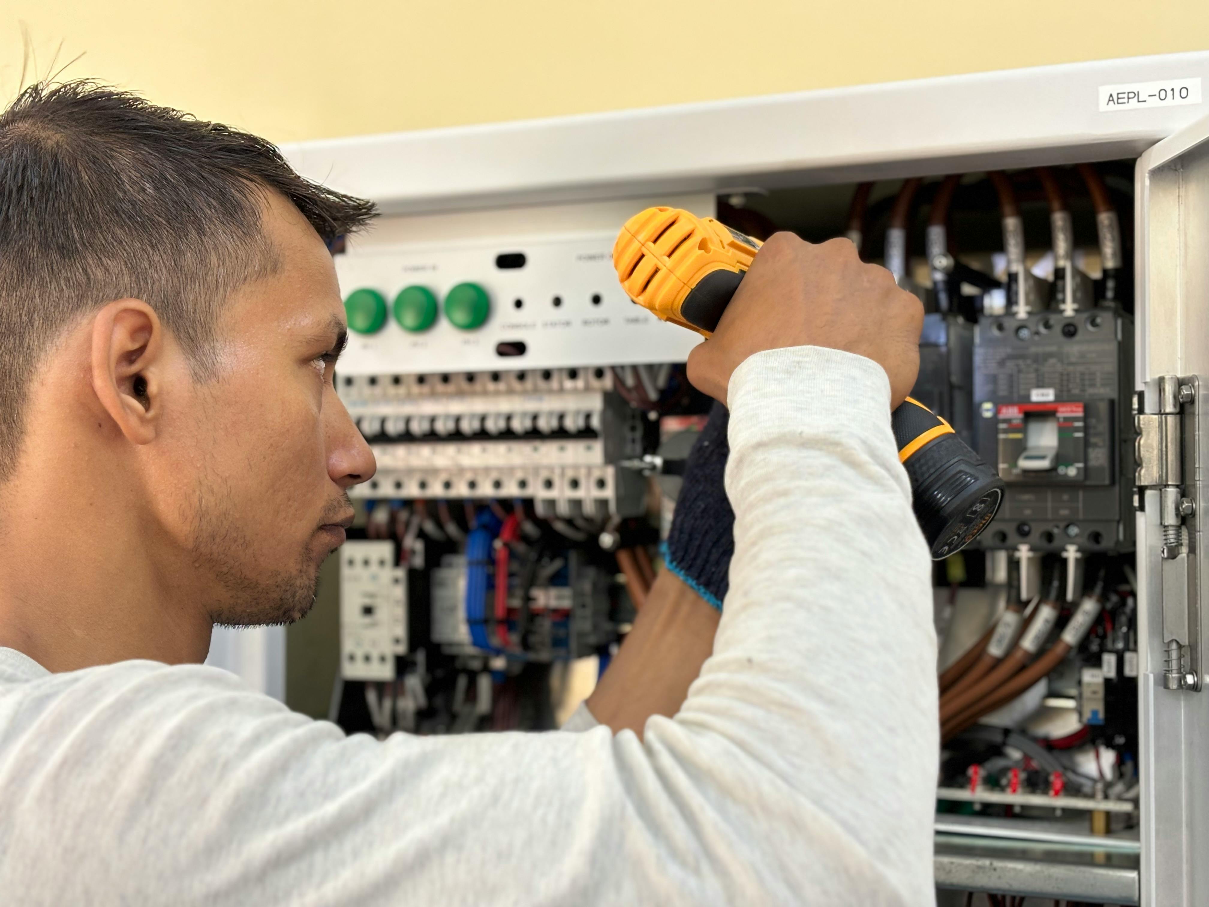 Electrician working on electrical panel